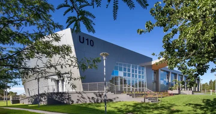 Nirimba is a leafy green campus is a learning hub combining modern architecture with rolling hills & blue skies