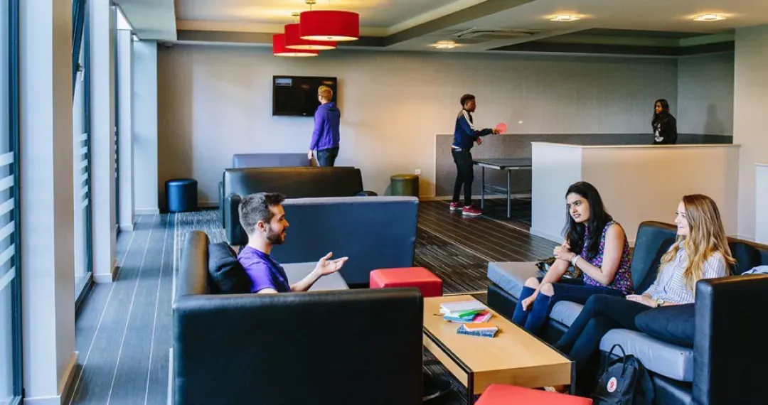 The common room at Central Village has a TV, pool table and games machines