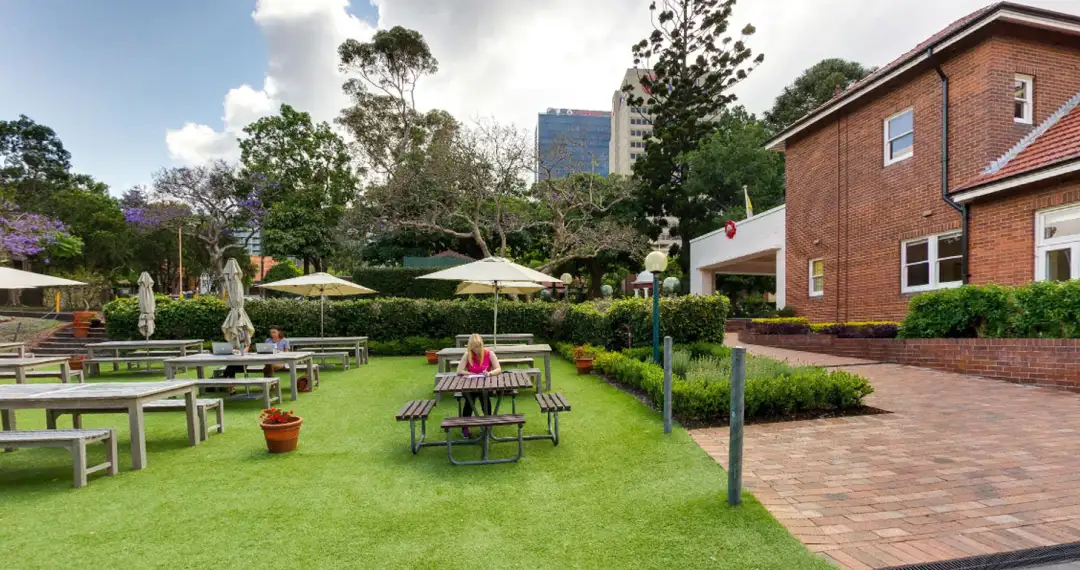 Courtyard, open-air area with landscaping that includes seating, pathways, and greenery