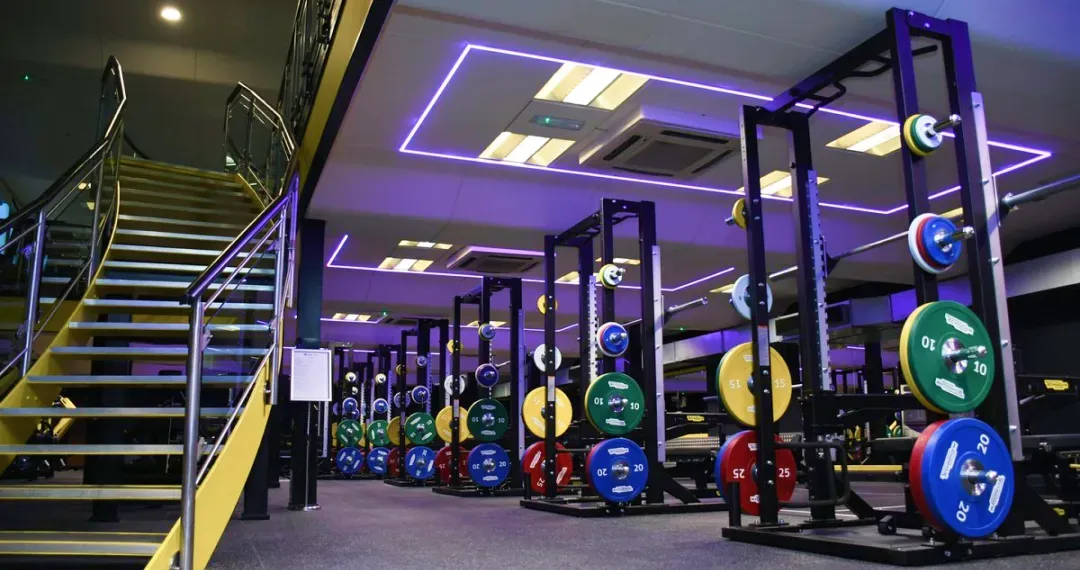It includes a well-equipped gym with cardio machines, weightlifting equipment, and free weights